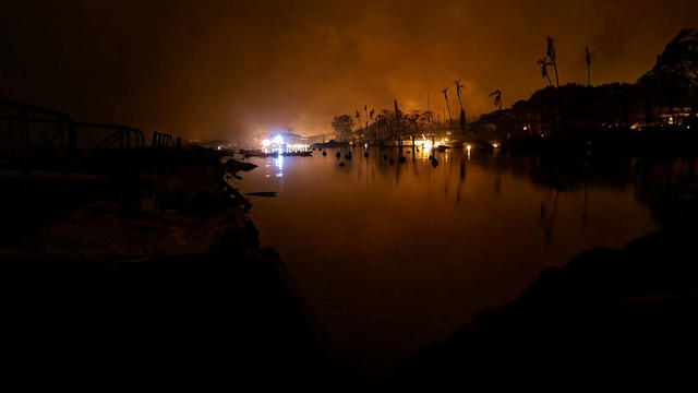 A wildfire burns on the island of Maui near an intersection in Lahaina, Hawaii, August 9, 2023. 
